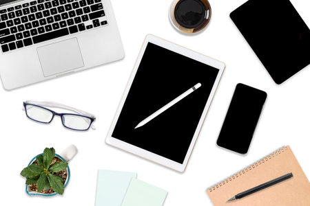 Flat lay photo of office table with laptop computer, digital tablet, mobile phone and accessories....