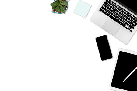 Flat lay photo of office table with laptop computer, digital tablet, mobile phone and accessories....