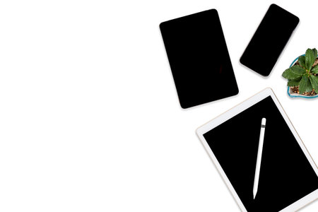 Flat lay photo of office table with laptop computer, digital tablet, mobile phone and accessories....