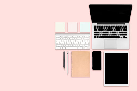 Flat lay photo of office table with laptop computer, digital tablet, mobile phone and accessories....