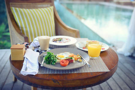 Breakfast served with fried egg, coffee, orange juice, cereals and fruits for healthy.の写真素材
