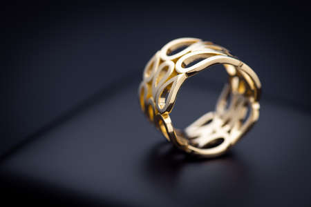 Luxury Engagement Yellow Gold Ring on Black Backgroundの写真素材