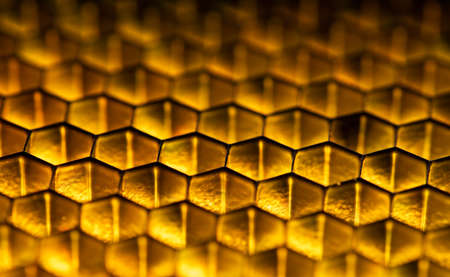 Golden yellow shiny honeycomb grid backgroundの写真素材