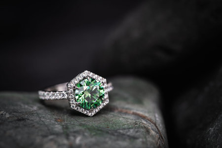 jewelry ring with green sapphire on a dark background