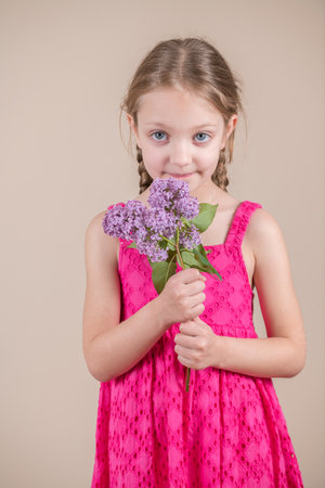 Little girl with a bouquet of lilacs in her hands.の写真素材