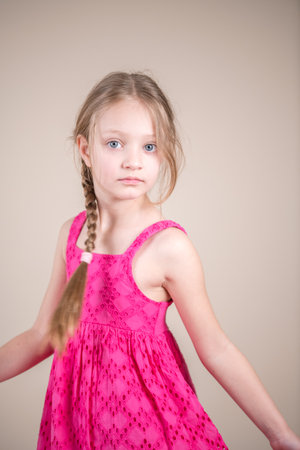 Portrait of a little girl in a pink dress. Studio shot.の写真素材