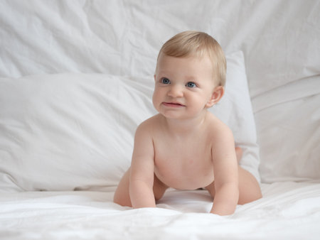 Portrait of a cute baby boy on the bed at home.の写真素材