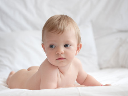 Cute little baby on white bed, closeup. Baby careの写真素材