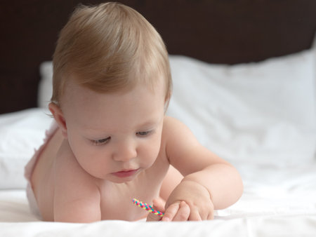 Cute little baby girl on the bed. Shallow DOFの写真素材