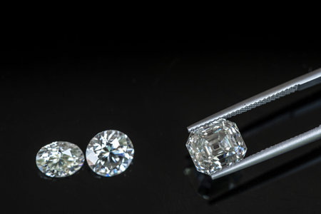 Jewelry tweezers with diamonds on a black background.