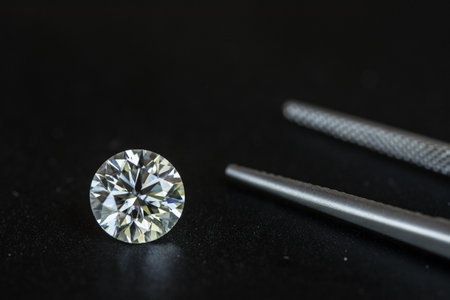 diamond and tweezers on a black background, close upの写真素材