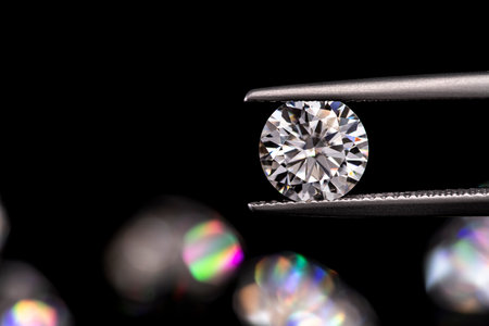 jewelry tweezers with diamond on a black background.の写真素材