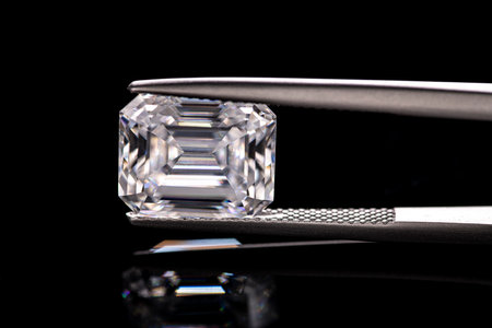 diamonds and tweezers on a black background close-upの写真素材
