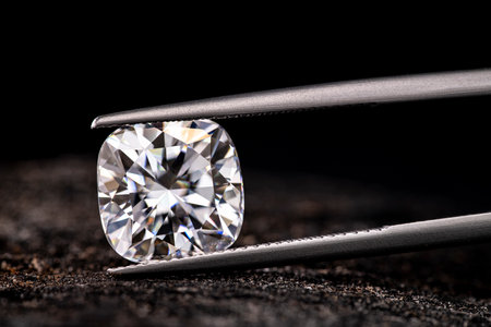 Diamonds and tweezers on black background. Jewelry concept.の写真素材