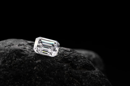 Diamond on black stone. Jewelry background. Macro shot with shallow DOF.の写真素材