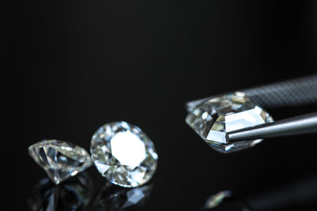 Three diamonds are on a black background. The diamonds are cut and polished, and they are displayed...