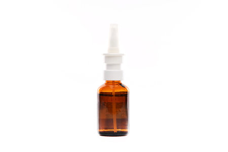 A brown bottle with a white cap and a white label. The bottle is sitting on a white background
