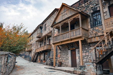 A vintage old stone building with a balcony and a staircase. The building has a rustic feel to itの写真素材