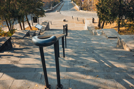 A staircase with a railing and a sign on it. The railing is black and the sign is white