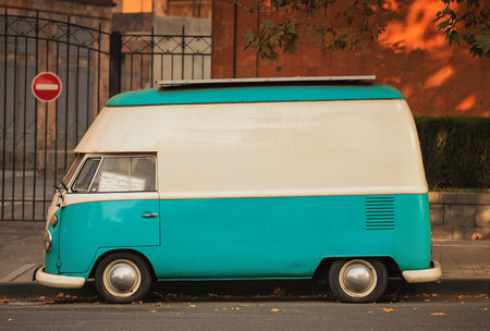 Yerevan Armenia 11.20.2025. A blue and white vintage van is parked on the side of the road. The van is old and has a vintage look to it. The blue and white color scheme gives the van a cheerful and playful vibeのeditorial素材
