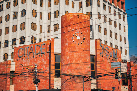 Yerevan Armenia 11.20.2025. A large red building with a clock on the side.の写真素材