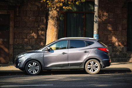 Yerevan Armenia 11.20.2025. A grey Hyundai SUV car is parked on the side of a street. The car is...