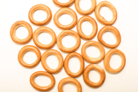 Delicious dry bagels on a white background.