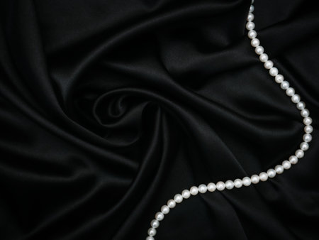 Luxury and sexy concept. Beautiful set of womens evening accessories. Pearl neck and silk black dress. Elegant classic female jewel. Decoration design. Soft focus. Luxury and sexy concept. Party timeの写真素材
