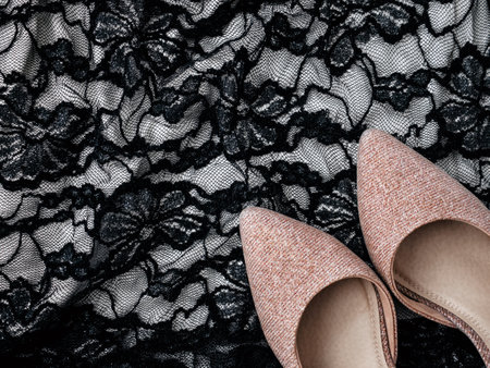 Glittery pink shoes and lace black dress as background. Sexy fashion concept with womens clothes and accessories. Flat lay, top view. Minimal feminine vogue concept. Party timeの写真素材