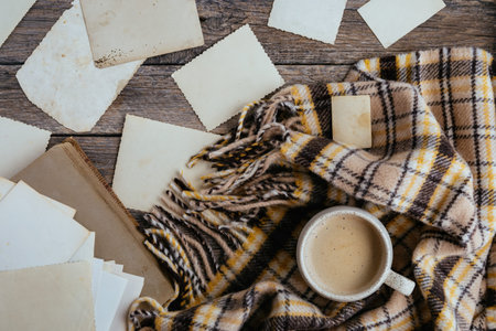 Clear blank photo frames to placed your pictures or text on wooden background with mug of coffee and...
