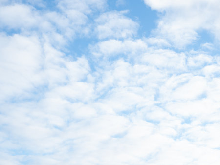 Soft and fluffy clouds formation on the bright sunny blue sky. Nature abstract background. Fresh air, weather conceptの写真素材