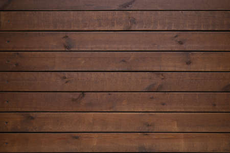 Shabby wooden wall background. Obsolete carpentry boards, panel. Surface of wooden texture for design and decoration. Dark brown horizontal wood plank grunge texture. Natural backdrop. Copy spaceの写真素材