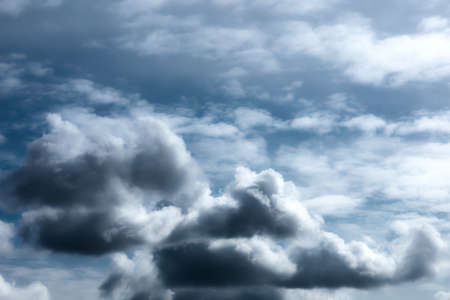 Stormy sky with rainy cumulus clouds. Moody dark blue thunderclouds. Beautiful thunderstorm landscape. Weather forecast concept. Abstract nature background.の写真素材