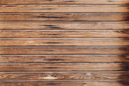 Shabby wooden wall background. Obsolete carpentry boards, panel. Surface of wooden texture for design and decoration. Dark brown horizontal wood plank grunge texture. Natural backdrop. Copy spaceの写真素材