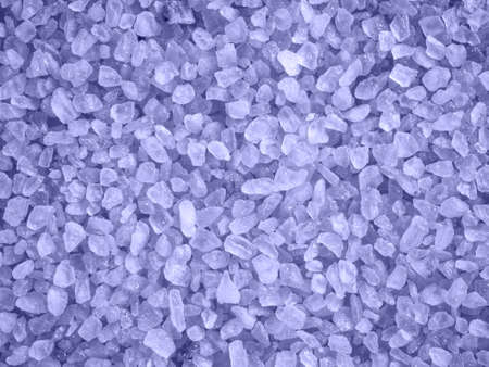 Purple colored salt crystals as a background. Aromatic lavander bath salt. Large sprinkled crystals of crimson sea salt. Beauty and body care concept. Close up.Trend color 2022 - Very Periの写真素材