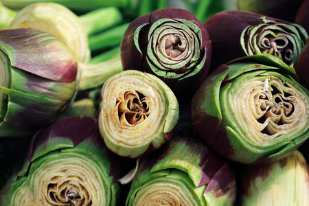 Close up of organic peeled artichokes in a box at outdoor farmers market. Cynara cardunculus var. Scolymus. Vegan food and healthy nutrition concept. Artichoke heart for sale in the street of Italy.の写真素材