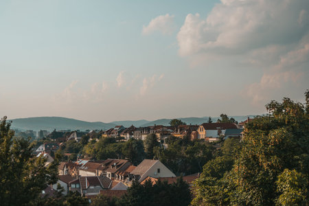 Orange brown tiled roof of the houses with solar panels. Traditional street. Amazing landscape with...