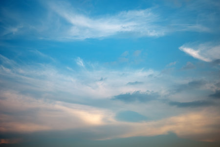 Majestic dusk. Beautiful bright blue sky with golden and grey clouds. Soft cloud in twilight. Calm cloudy sky on evening time. Abstract nature background. Fresh air, weather and freedom conceptの写真素材