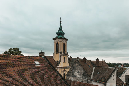 Brown tiled roof of the houses and Blagovestenska Church in Szentendre. Details of different...