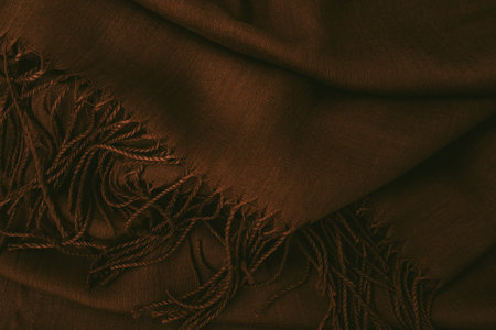 Deep, rich, brown colored cashmere scarf. Folded and flowing background. Decoration design. Luxury...