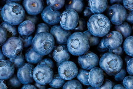 Bright yummy blueberry or great bilberry background. Heap, pile of dark blue berries. Antioxidant organic superfood. Healthy meal snack. Top view. Bog whortleberry. Vaccinium uliginosumの写真素材