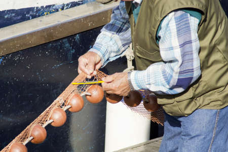 Fisher clinches the fishing netの写真素材