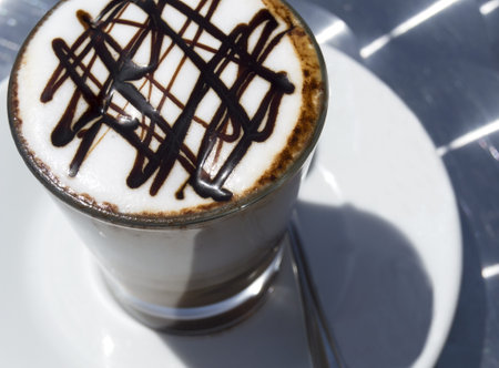beautifully decorated cup of hot coffee with a star shape chocolate 