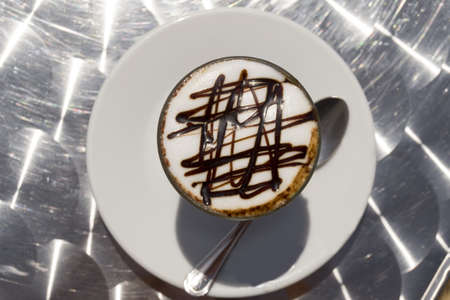 beautifully decorated cup of hot coffee with a star shape chocolate の写真素材