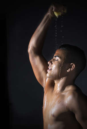 young athlete cools down with waterの写真素材