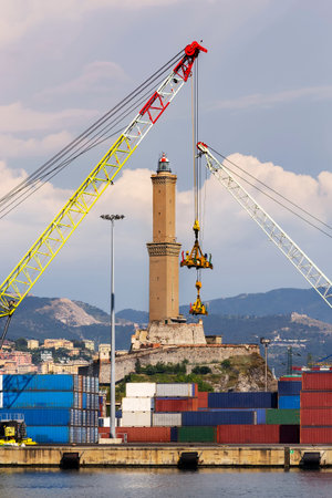 The lighthouse of Genoa between two cranes