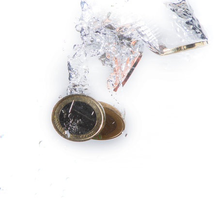 coins of euro sink in waterの写真素材