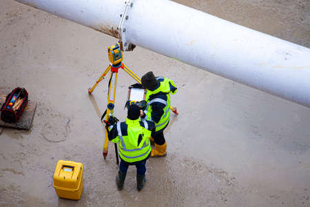 Surveyors working at new construction siteの写真素材