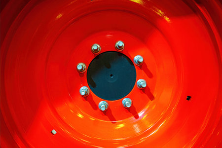 Close up of a red wheel of an agricultural machine in the fieldの写真素材