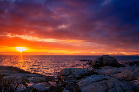 View of a cloudy sunrise from Boulders beach with a view of False Bay, Simon's Town, Cape Town,...